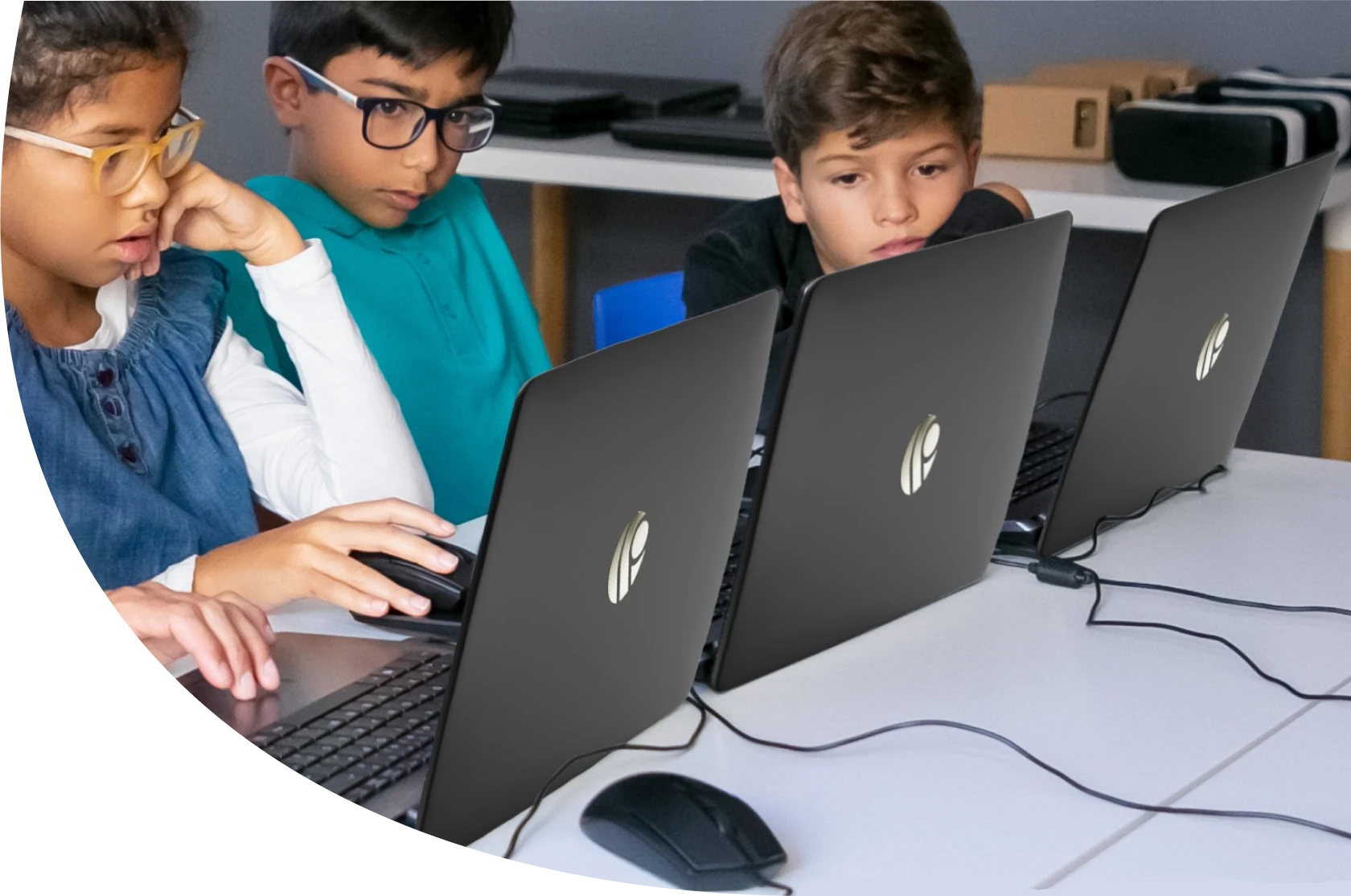 Three kids joyfully using sleek Primebook laptops while captivated by the screen.